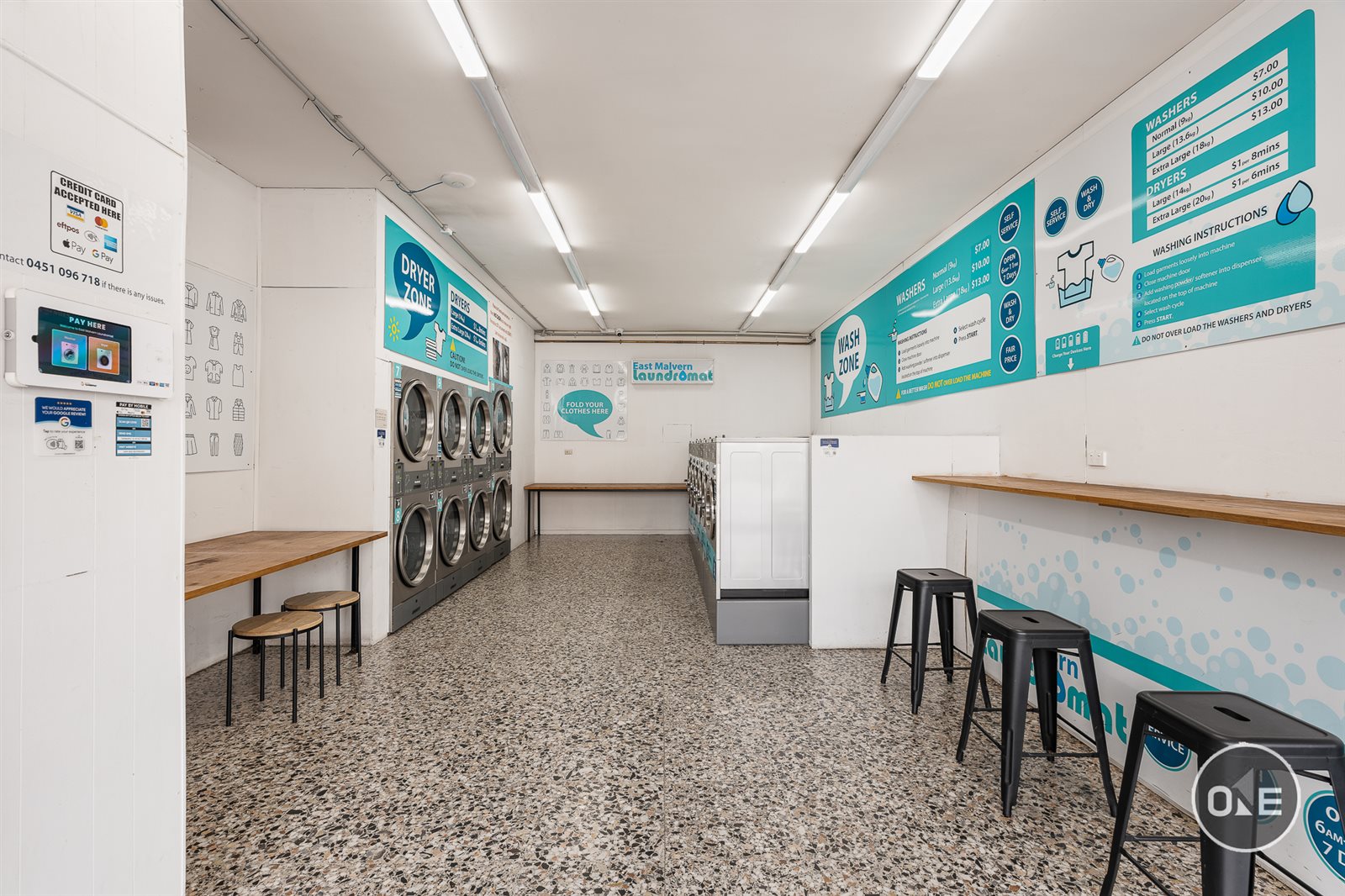 Real laundromat interior with commercial washers and dryers in Malvern East